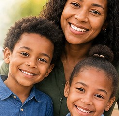 Alabama mother and children smiling, a family exploring Alabama assistance programs